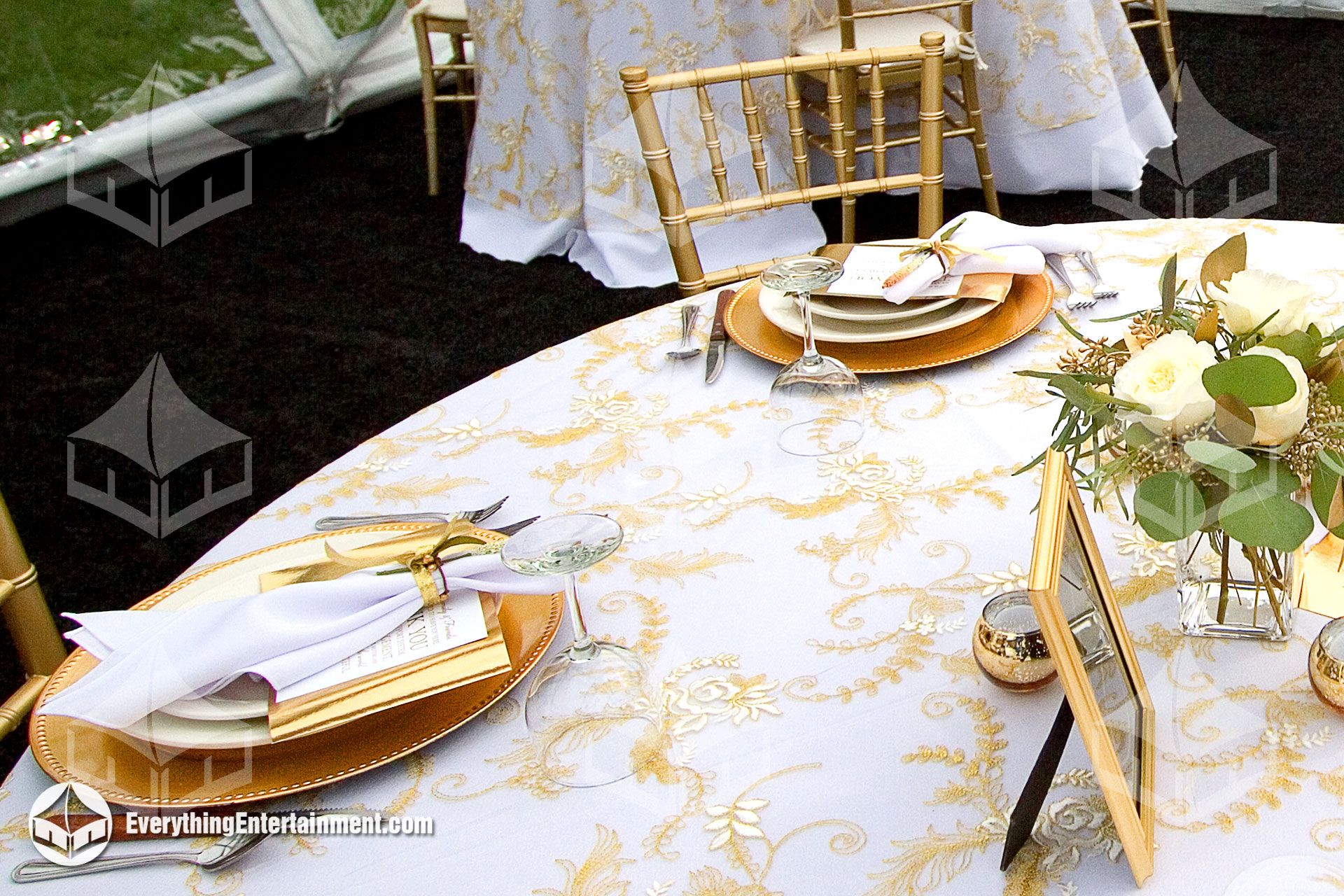 white table linen with gold patterned overlay
