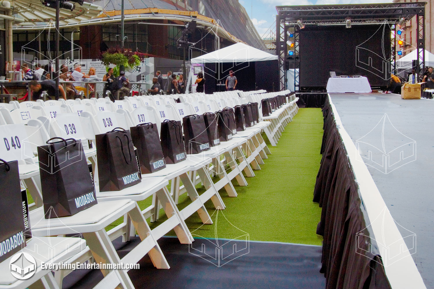 Fashion show runway setup featuring sleek stage design, stylish seating, vibrant lighting, and a professional backdrop provided by Everything Entertainment for NYC Fashion Week