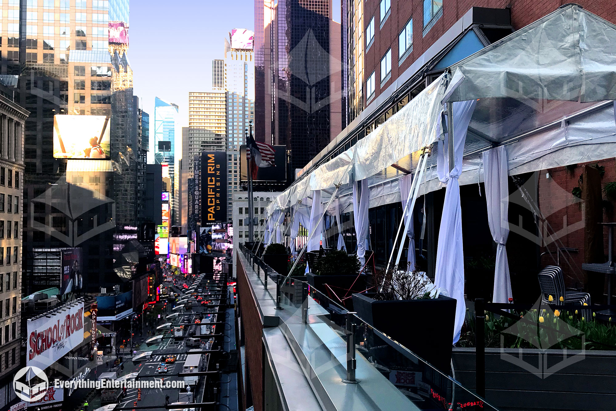 A frame tent set up on a rooftop overlooking Times Square in NYC.