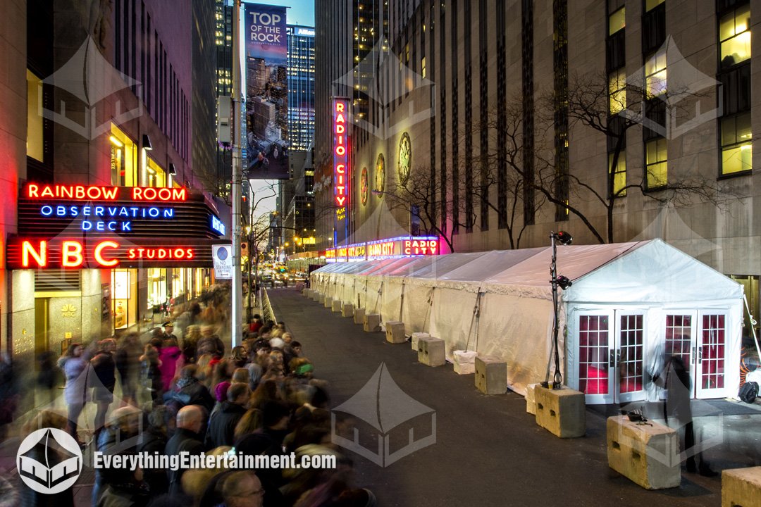 Exterior night view of a 15x150 Everything Entertainment frame tent with glass doors set up outside Radio City Music Hall on a New York City sidewalk.