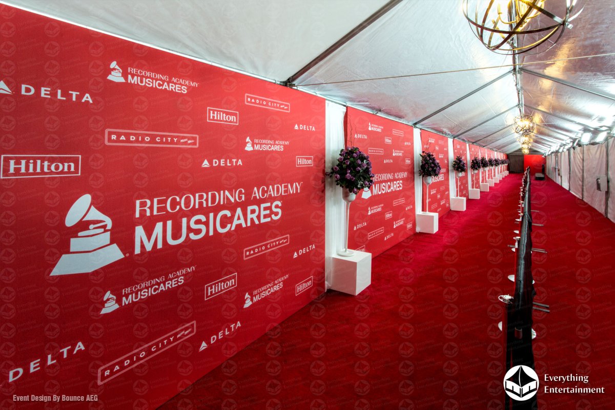 Long red carpet carpeted walkway inside a 15x150 tent with branded MusiCares step and repeat wall set up by Everything Entertainment at Radio City Music Hall in NYC.