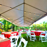 long tent with string lights, tables and chairs