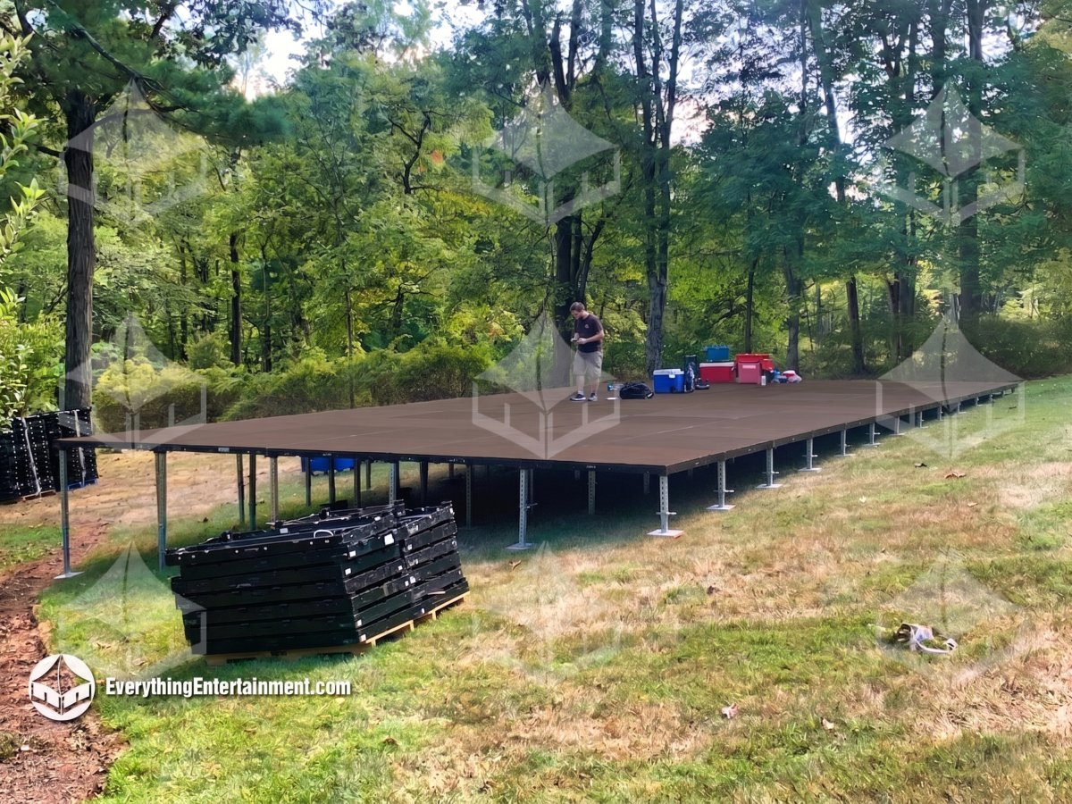 Custom engineered elevated subfloor installation built on a steep backyard slope ranging from zero to seven feet high by Everything Entertainment.