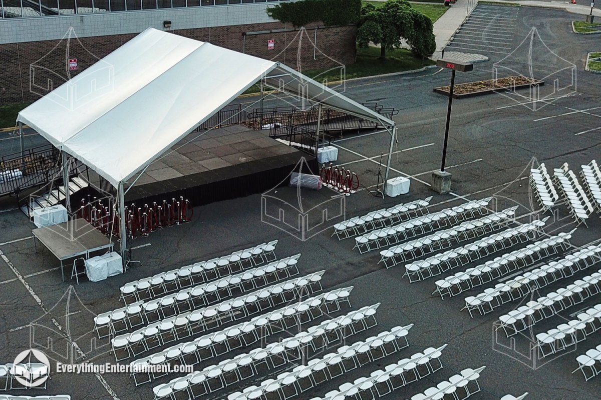High-angle aerial view of a 40x30 open gable frame tent covering a commencement stage with 2,500 white folding chairs set up for a college graduation in Union NJ by Everything Entertainment.