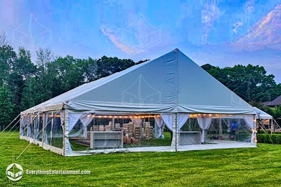 40x50 frame tent with clear walls in backyard during the daytime in Coltsneck, NJ
