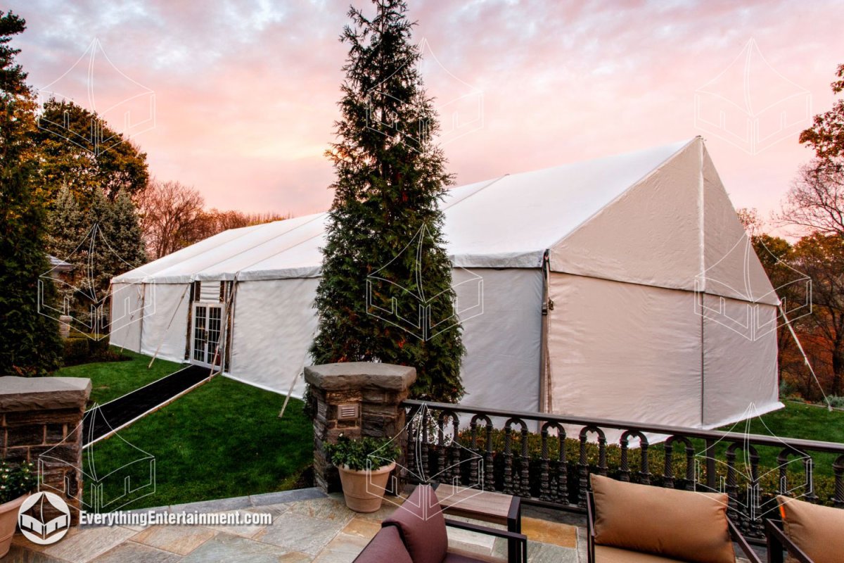 Exterior view of a 40x70 maxi frame tent with French entry doors and a black carpet runner in a private Upper Saddle River backyard by Everything Entertainment