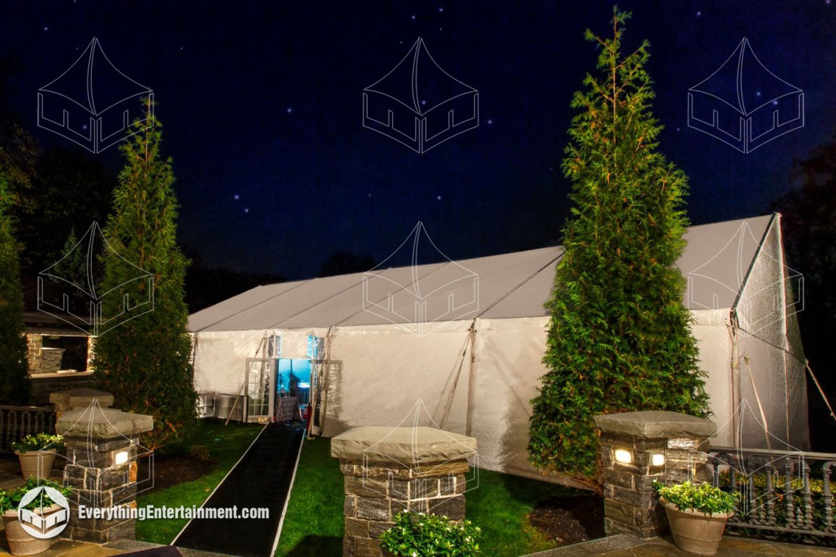 Evening view of a fully illuminated 40x70 frame tent and entrance pathway set up for a private estate event by Everything Entertainment.