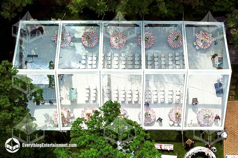 Aerial view of a 40x75 clear top frame tent installation on a white carpeted subfloor for a private backyard wedding in Teaneck, New Jersey.