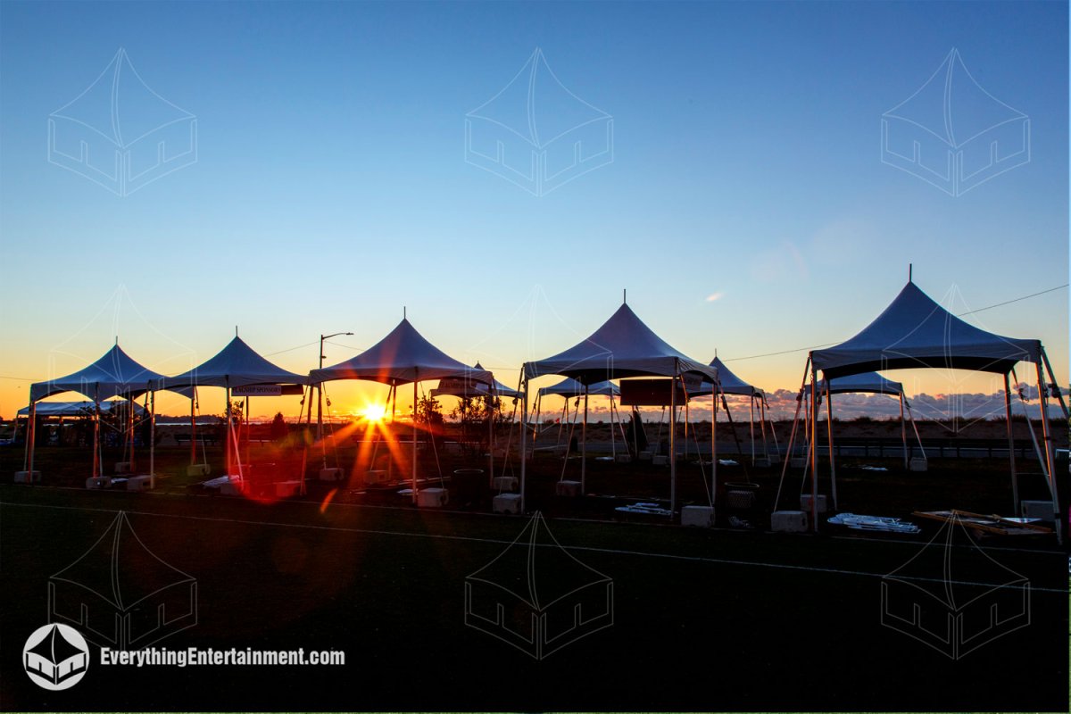Lineup of high peak marquees with concrete ballasts at dawn for the Staten Island Making Strides walk by Everything Entertainment.