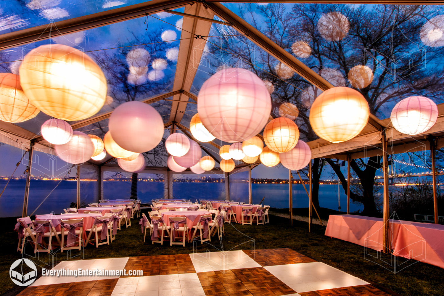 Clear top tent with large light up paper lanterns in the early evening