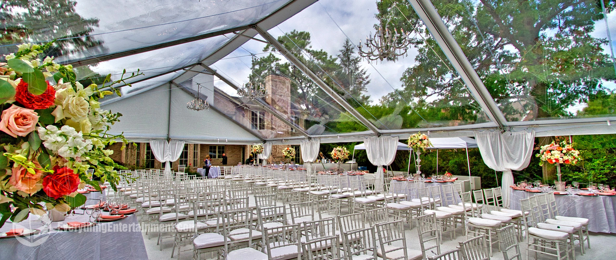 A large 40x100 foot clear top frame tent with chairs set up for wedding ceremony in Teaneck, NJ