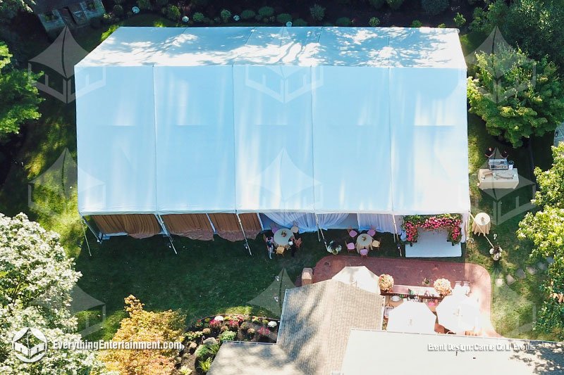 Aerial view of a white 50x75 maxi-frame tent installed in a lush backyard in Colts Neck New Jersey by Everything Entertainment.