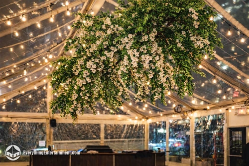large handing greenery floral chandelier inside tent