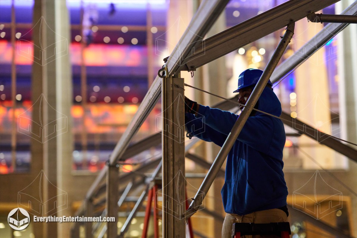Illuminated multi-tent complex set up on Event Deck flooring for a movie premiere at Lincoln Center at night.