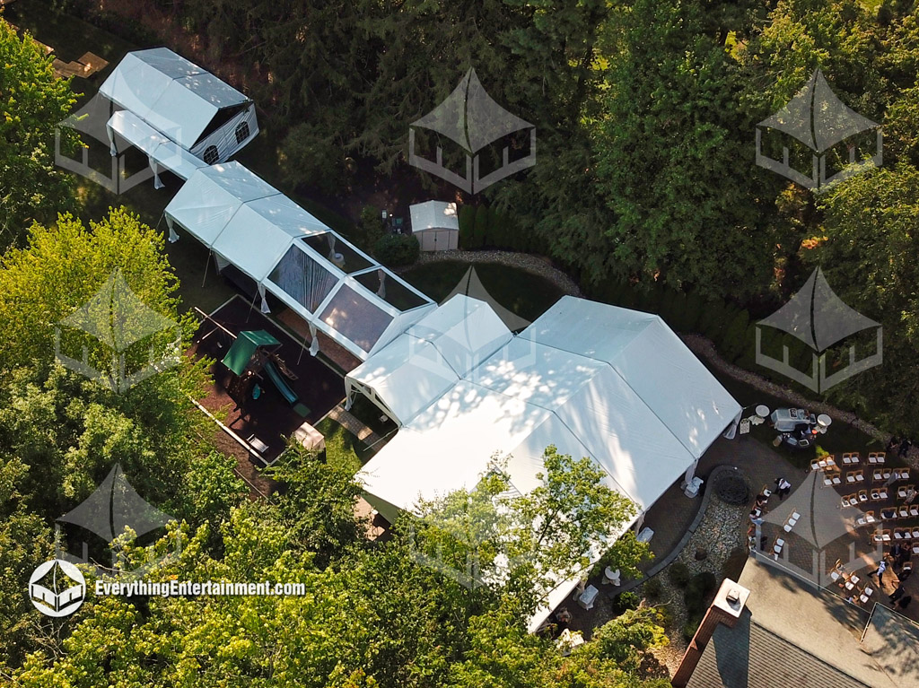 An aerial view of multiple tents in a backyard linked together.