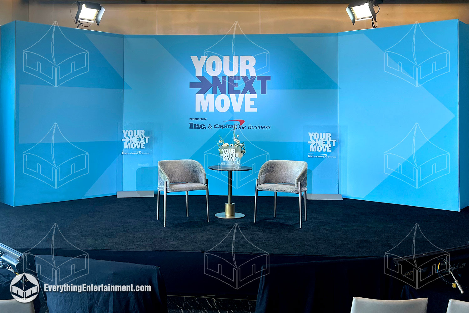 Stage setup by Everything Entertainment featuring branded elements, sleek design, and professional lighting for impactful events.