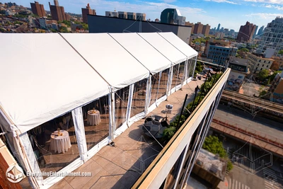 A 20x50 foot frame tent on a Brooklyn, NY rooftop overlooking the NY skyline