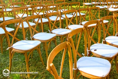 Rustic cross back chairs setup on grass in a semi-circle for a wedding in Freehold, NJ