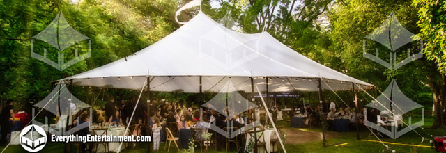 sailcloth wedding tent with sunrays shining through trees