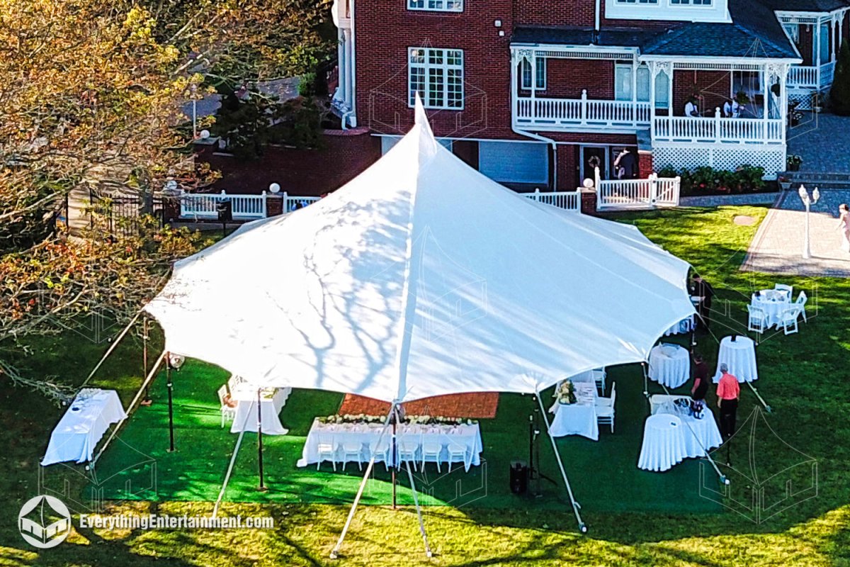 High aerial view of a white sailcloth tent setup on a green subfloor in a Staten Island backyard by Everything Entertainment.