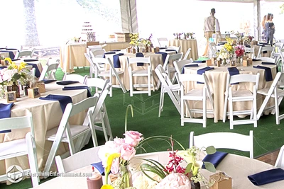 Tables and chairs set up around tables with linens inside a tent rental at the Alice Austen House, Staten Island
