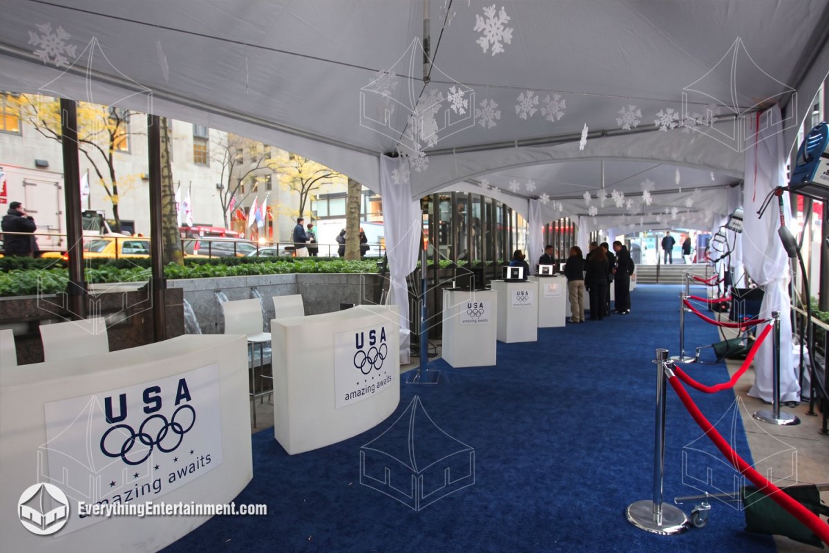 Interior of connected 15x20 high peak tents with blue carpet and Team USA counters at Rockefeller Center by Everything Entertainment.