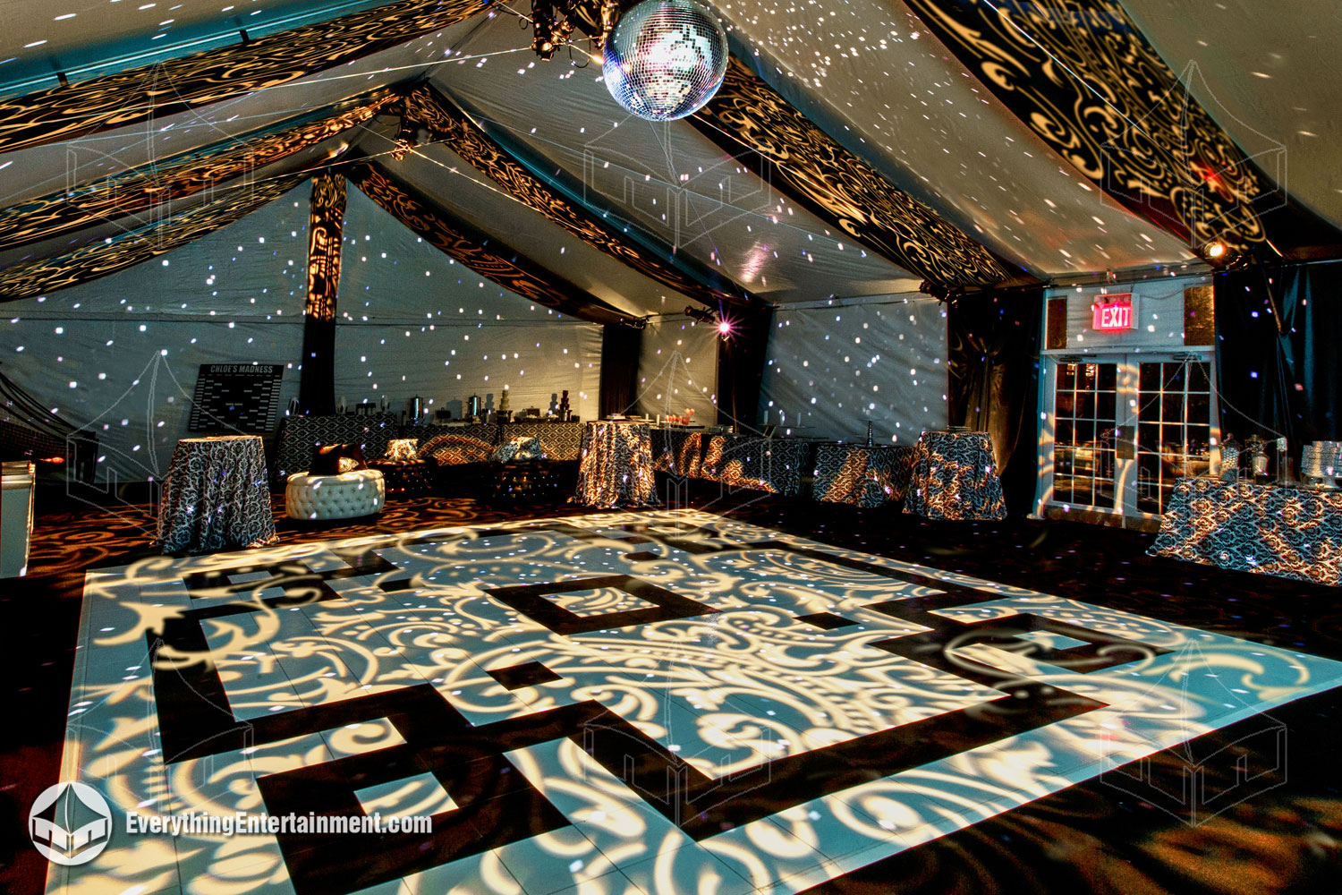 tented interior with black and white dance floor, plus black drapes and unique lighting