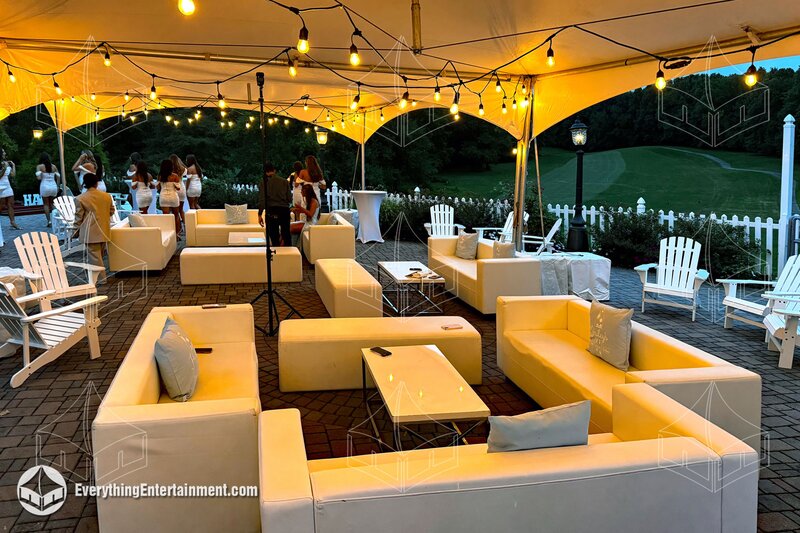 tents with lounge furniture and bistro string lighting