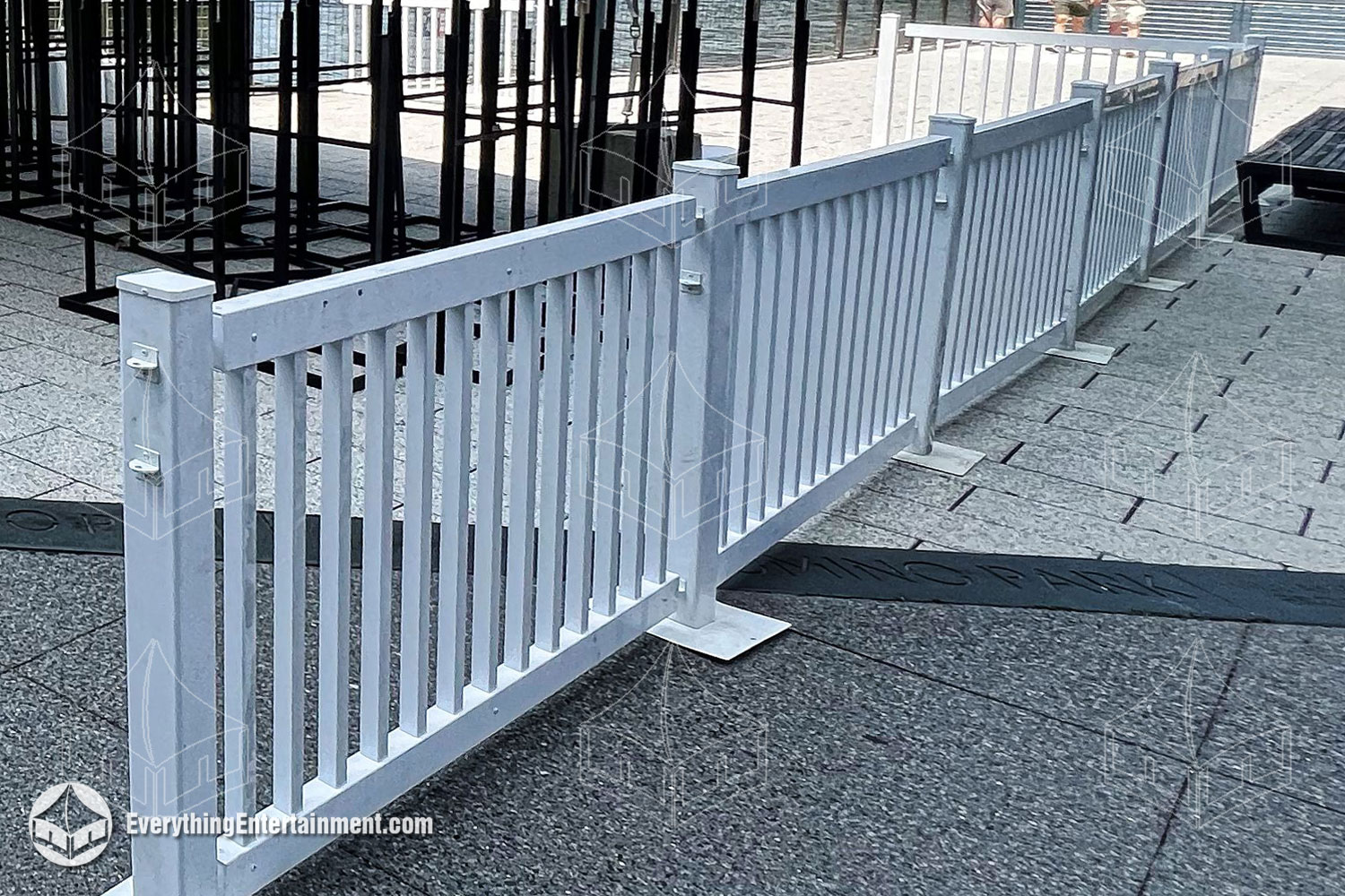 White picket fence set up on stone tiles